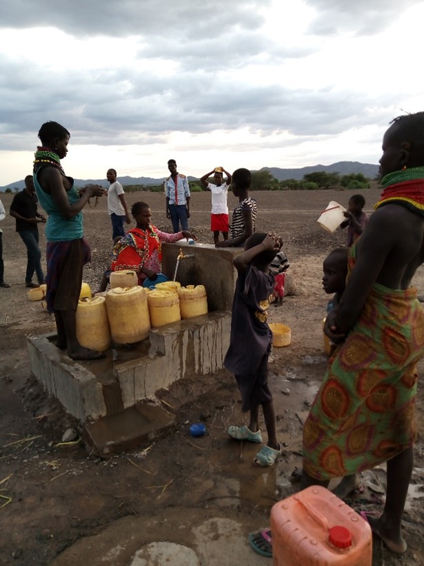 Beneficiaries fetching water school yard tap